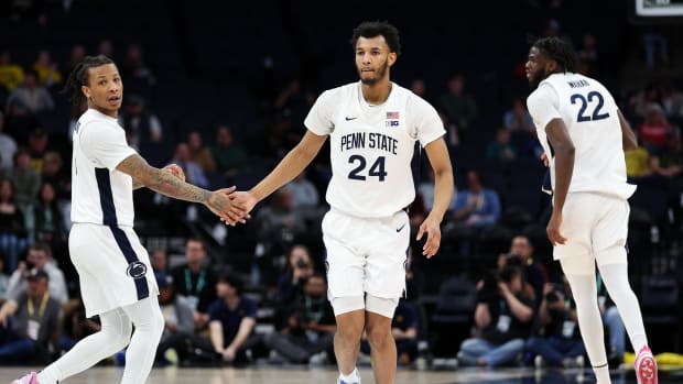 Penn State's Ace Baldwin Jr. (left) congratulates Zach Hicks after a 3-pointer against Michigan in the Big Ten Men's Basketball Tournament.